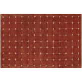 Modern geometric accent rug in red and white cross-stitch design.